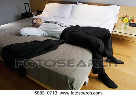 Businessman lying on the bed and thinking View Large Photo Image Stock Image - Businessman lying on the bed and thinking. Fotosearch