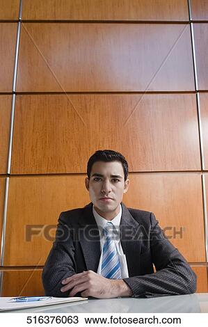 Businessman sitting at a desk and thinking View Large Photo Image Stock Image - Businessman sitting at a desk and thinking. Fotosearch