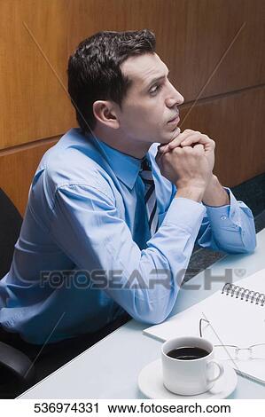 Businessman sitting in an office chair and thinking View Large Photo Image Stock Image - Businessman sitting in an office chair and thinking. Fotosearch