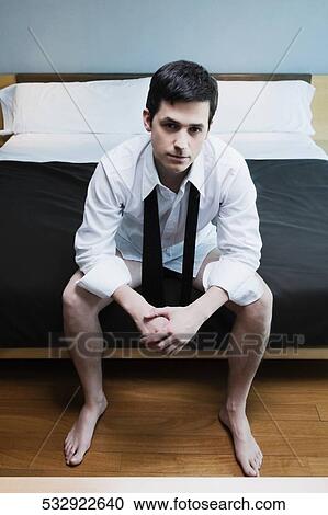 Businessman sitting on the bed and thinking View Large Photo Image Stock Image - Businessman sitting on the bed and thinking. Fotosearch