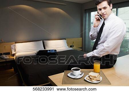 Businessman talking on a mobile phone View Large Photo Image Stock Image - Businessman talking on a mobile phone. Fotosearch