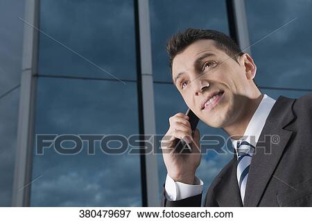 Businessman talking on a mobile phone View Large Photo Image Stock Photo - Businessman talking on a mobile phone. Fotosearch