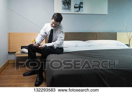 Businessman talking on the telephone and writing View Large Photo Image Stock Image - Businessman talking on the telephone and writing. Fotosearch