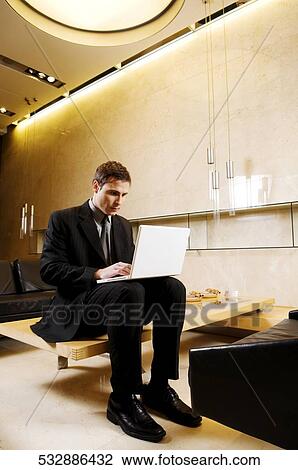 Businessman working on a laptop View Large Photo Image Stock Image - Businessman working on a laptop. Fotosearch