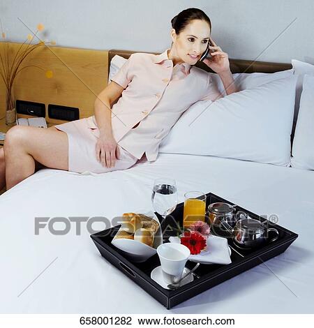 Stock Image - Businesswoman talking on a mobile phone. Fotosearch