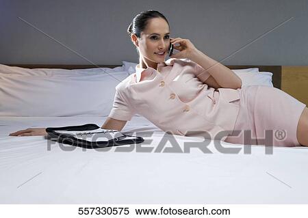 Businesswoman talking on a mobile phone View Large Photo Image Stock Photography - Businesswoman talking on a mobile phone. Fotosearch