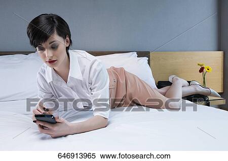 Businesswoman using a personal data assistant View Large Photo Image Stock Photography - Businesswoman using a personal data assistant. Fotosearch