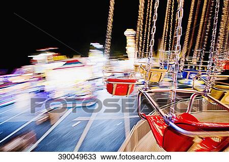 Chain swing ride spinning in an amusement park View Large Photo Image Stock Image - Chain swing ride spinning in an amusement park. Fotosearch