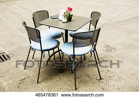 Stock Image - Chairs around a table at a sidewalk cafe, Piazza Matteotti, Genoa, Italy. Fotosearch
