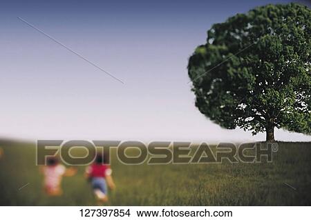 Picture - Children running in a park. Fotosearch