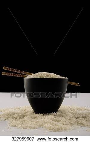 Stock Photo - Chopsticks on a bowl full of rice. Fotosearch