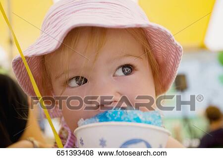 Close-up of a baby girl eating an ice cream View Large Photo Image Stock Photo - Close-up of a baby girl eating an ice cream. Fotosearch