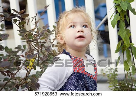Close-up of a baby girl looking up View Large Photo Image Stock Image - Close-up of a baby girl looking up. Fotosearch
