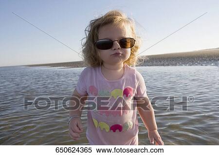 Close-up of a baby girl wearing sunglasses View Large Photo Image Stock Photography - Close-up of a baby girl wearing sunglasses. Fotosearch