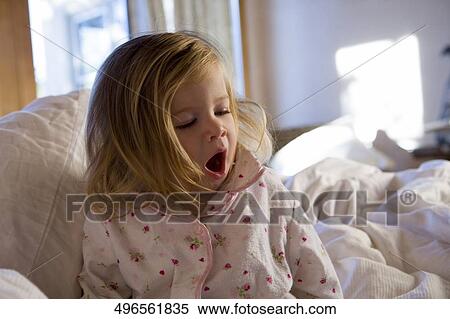 Close-up of a baby girl yawning View Large Photo Image Stock Photography - Close-up of a baby girl yawning. Fotosearch
