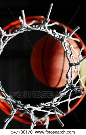 Close-up of a basketball in a hoop View Large Photo Image Stock Image - Close-up of a basketball in a hoop. Fotosearch