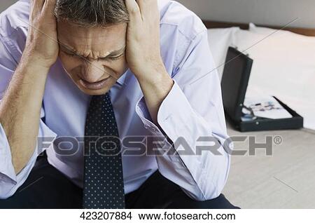 Picture - Close-up of a businessman suffering from a headache. Fotosearch