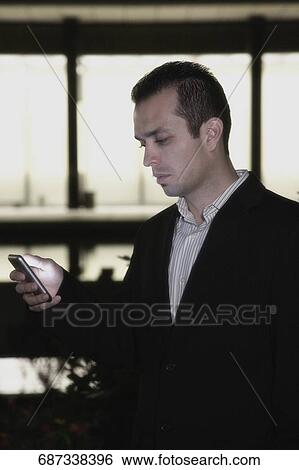 Stock Photograph - Close-up of a businessman text messaging. Fotosearch