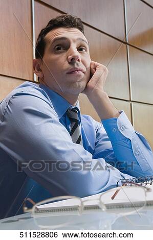 Close-up of a businessman thinking View Large Photo Image Stock Photograph - Close-up of a businessman thinking. Fotosearch