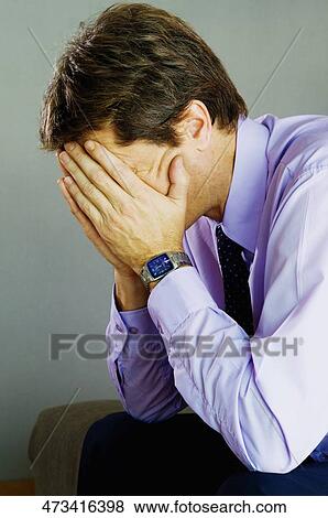 Close-up of a businessman with his head in his hands View Large Photo Image Stock Photo - Close-up of a businessman with his head in his hands. Fotosearch