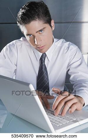 Close-up of a businessman working on a laptop View Large Photo Image Stock Image - Close-up of a businessman working on a laptop. Fotosearch