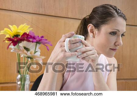 Close-up of a businesswoman holding a cup of coffee View Large Photo Image Stock Image - Close-up of a businesswoman holding a cup of coffee. Fotosearch