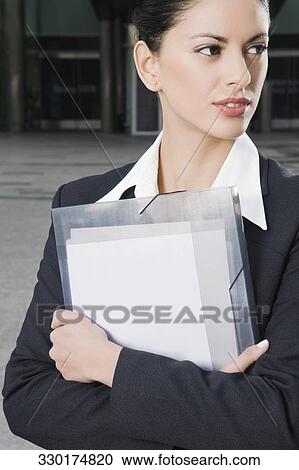 Close-up of a businesswoman holding files View Large Photo Image Stock Image - Close-up of a businesswoman holding files. Fotosearch