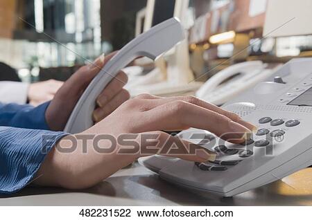 Close-up of a businesswoman's hand using a telephone View Large Photo Image Stock Image - Close-up of a businesswoman's hand using a telephone. Fotosearch