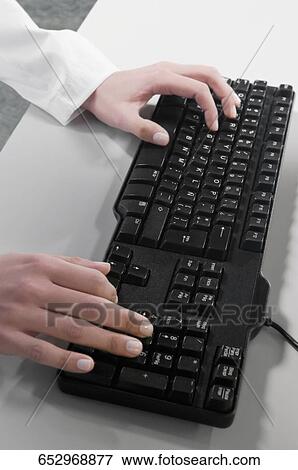 Close-up of a businesswoman's hand typing on a computer keyboard View Large Photo Image Stock Photo - Close-up of a businesswoman's hand typing on a computer keyboard. Fotosearch