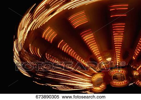 Close-up of a carousel spinning at night View Large Photo Image Stock Photography - Close-up of a carousel spinning at night. Fotosearch