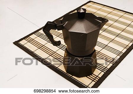 Close-up of a coffee maker on a place mat View Large Photo Image Picture - Close-up of a coffee maker on a place mat. Fotosearch