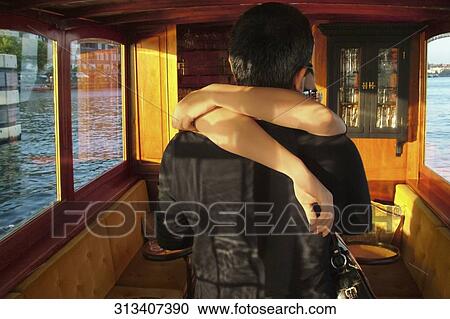 Close-up of a couple embracing each other in a tourboat View Large Photo Image Stock Image - Close-up of a couple embracing each other in a tourboat. Fotosearch