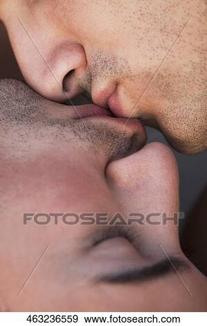Close-up of a gay couple kissing each other View Large Photo Image Stock Photo - Close-up of a gay couple kissing each other. Fotosearch