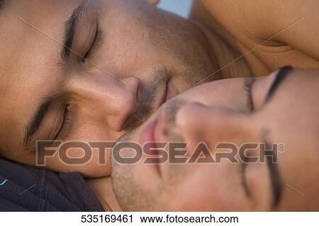 Close-up of a gay couple romancing View Large Photo Image Stock Image - Close-up of a gay couple romancing. Fotosearch