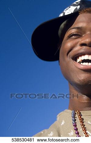 Close-up of a gay man smiling View Large Photo Image Stock Image - Close-up of a gay man smiling. Fotosearch
