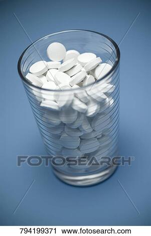 Close-up of a glass full of pills View Large Photo Image Stock Image - Close-up of a glass full of pills. Fotosearch
