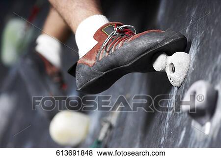 Close-up of a man climbing a wall View Large Photo Image Stock Photo - Close-up of a man climbing a wall. Fotosearch