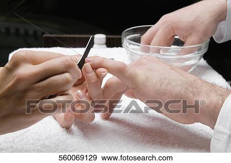 Close-up of a man's hand getting manicure View Large Photo Image Stock Photo - Close-up of a man's hand getting manicure. Fotosearch
