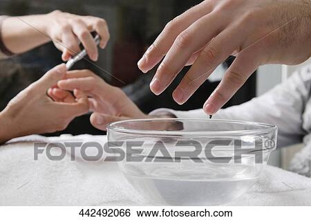 Close-up of a man's hand getting manicure View Large Photo Image Stock Photograph - Close-up of a man's hand getting manicure. Fotosearch