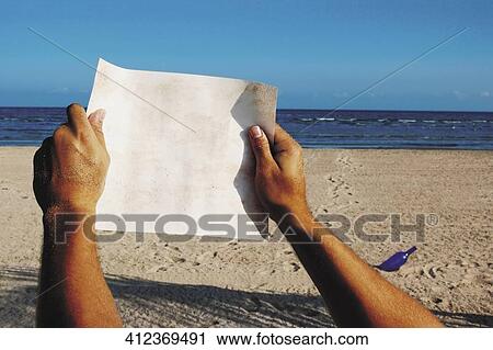 Close-up of a man's hand holding a blank paper View Large Photo Image Stock Image - Close-up of a man's hand holding a blank paper. Fotosearch