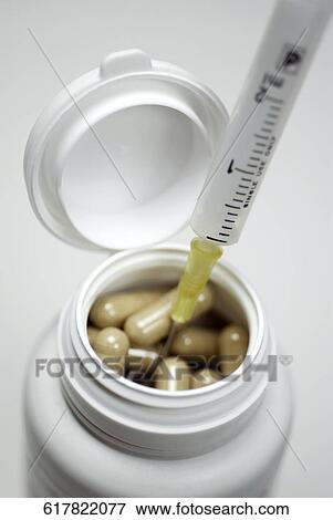 Close-up of a medical injection with capsules in a jar View Large Photo Image Stock Photo - Close-up of a medical injection with capsules in a jar. Fotosearch
