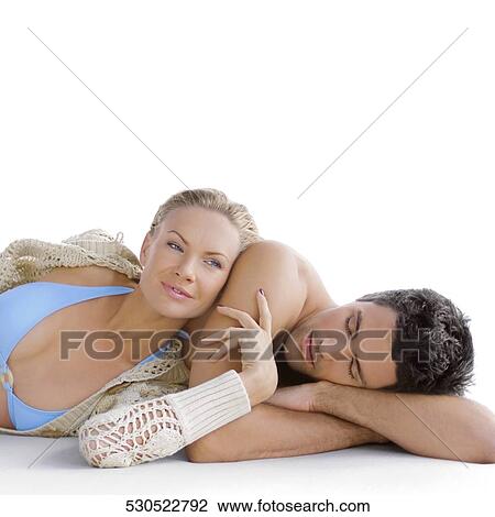 Stock Image - Close-up of a mid adult couple resting. Fotosearch