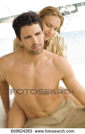 Close-up of a mid adult couple romancing at poolside View Large Photo Image Stock Image - Close-up of a mid adult couple romancing at poolside. Fotosearch