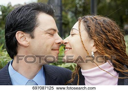 Close-up of a mid adult man and a young woman rubbing their noses View Large Photo Image Stock Photography - Close-up of a mid adult man and a young woman rubbing their noses. Fotosearch