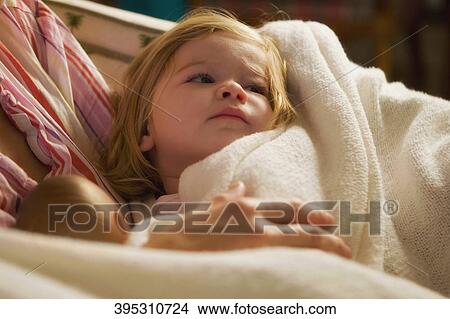Close-up of a mid adult woman holding her baby girl View Large Photo Image Picture - Close-up of a mid adult woman holding her baby girl. Fotosearch