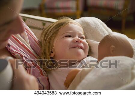 Close-up of a mid adult woman holding her baby girl View Large Photo Image Stock Image - Close-up of a mid adult woman holding her baby girl. Fotosearch