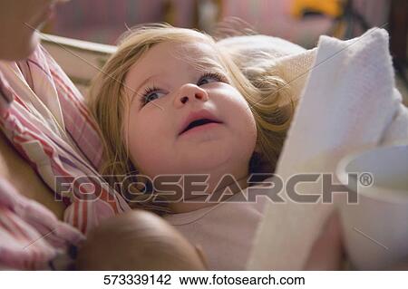 Close-up of a mid adult woman holding her baby girl View Large Photo Image Stock Image - Close-up of a mid adult woman holding her baby girl. Fotosearch