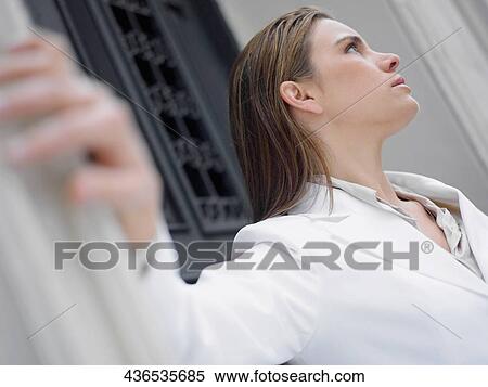 Close-up of a mid adult woman looking serious View Large Photo Image Stock Photography - Close-up of a mid adult woman looking serious. Fotosearch