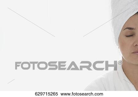 Stock Photography - Close-up of a mid adult woman meditating. Fotosearch
