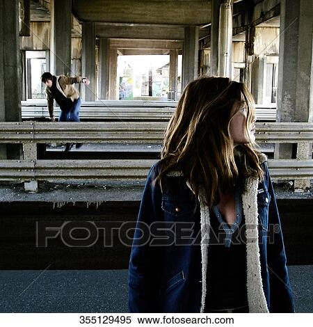 Close-up of a mid adult woman standing at a railroad station platform View Large Photo Image Stock Photography - Close-up of a mid adult woman standing at a railroad station platform. Fotosearch